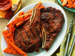 spicy ribeyes with ginger orange grilled carrots recipe image