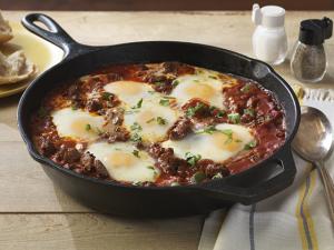 saucy beef with baked eggs recipe image