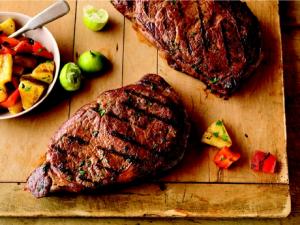 caribbean ribeye steaks with grilled pineapple salad recipe image
