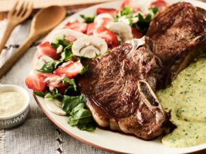 beef strip steaks with kale polenta and mushroom-strawberry salad recipe image