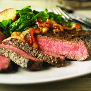 peppered beef steaks with caramelized onions recipe image