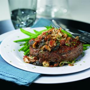 steaks with mushrooms, blue cheese & frizzled shallots recipe image