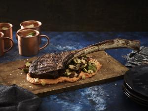 tomahawk steak with grilled brussels sprouts and sweet potato purée recipe image